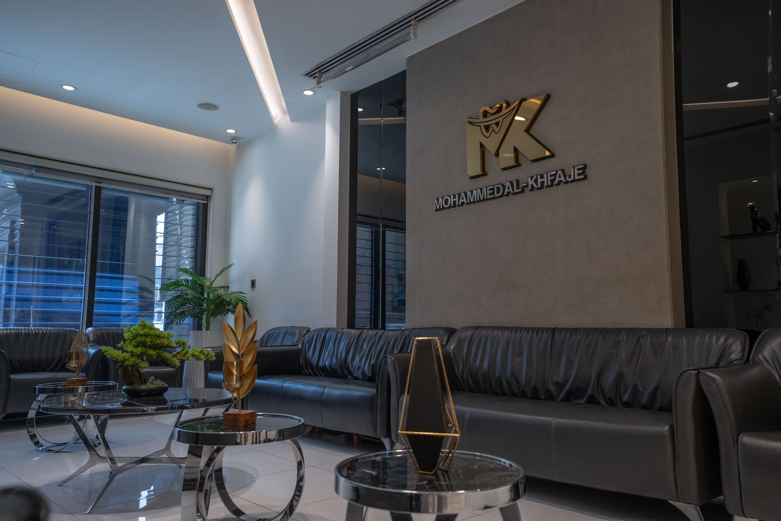 The gold MK logo on the feature wall above the waiting lounge
