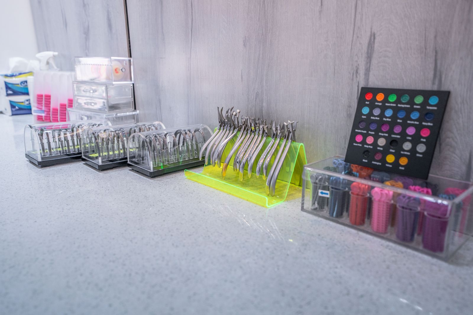 Orthodontic pliers and coloured elastic ties laid out for treatment