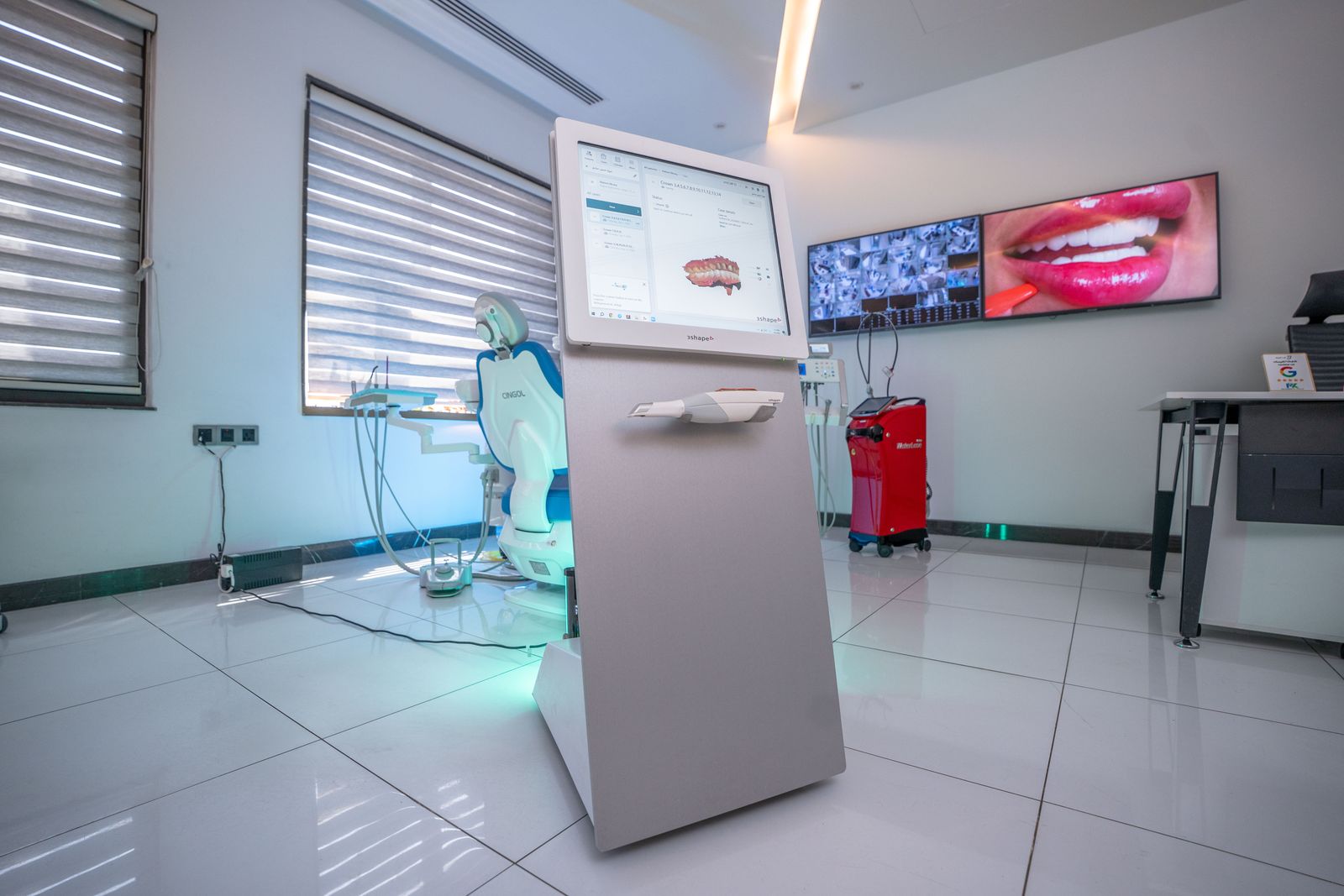 A 3Shape intraoral scanner displaying a digital scan of the teeth
